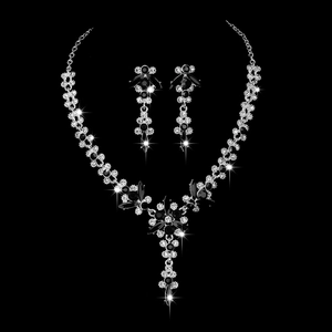 Close-up of bridal jewelry set with black gemstones and crystals on black background