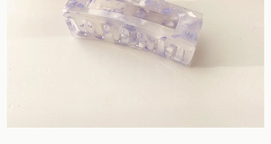 Macro detail of a large purple marble acrylic hair claw clip with non-slip square design