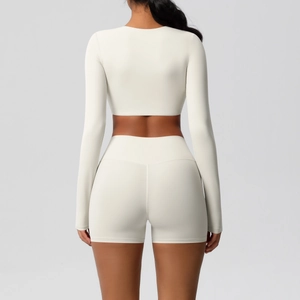 Rear view of off-white seamless yoga set with long sleeve crop top and high waist shorts