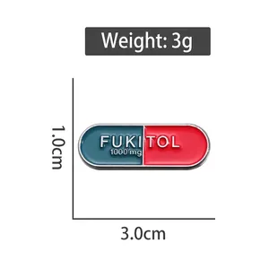 Creative capsule enamel pin with Fukitol text in red and blue, size 3.0cm by 1.0cm