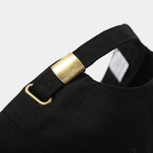 Detail of adjustable metal buckle and stitching on black cotton baseball cap strap