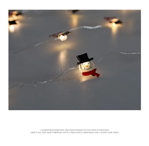 Close-up of warm white LED snowman fairy lights with soft bokeh background effect