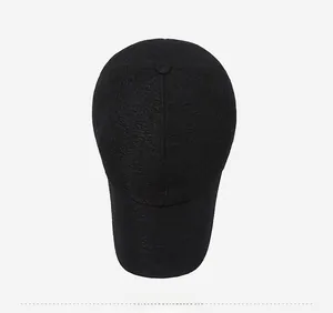 Top down view of black baseball cap showing detailed crinkled fabric texture