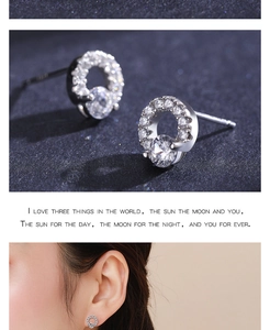 Macro shot of S925 sterling silver round pave zircon stud earrings with model on ear view
