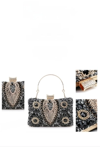 Detailed view of luxury evening clutch with black gems and sparkling crystals