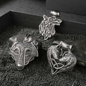 Vintage silver Viking wolf pendants with Celtic knot and heart shapes on black stone