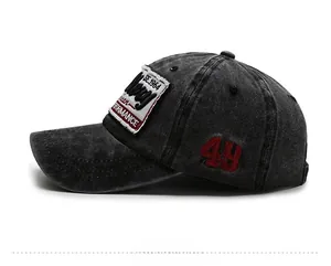 Detail view of washed cotton baseball cap with vintage red 49 embroidery and fabric patch