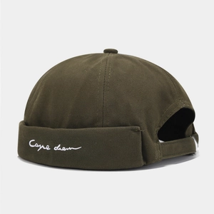 Detail of army green docker cap featuring white Carpe Diem embroidery on cotton twill
