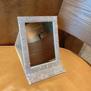Detailed view of luxury foldable desktop makeup mirror with sparkling rhinestones and PU leather