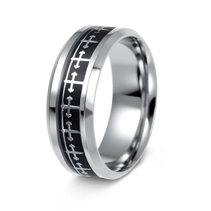 Macro shot of silver stainless steel ring with black cross patterns and brushed finish