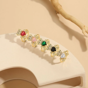 Detail of five 14K gold butterfly rings with colorful heart stones and zircon settings