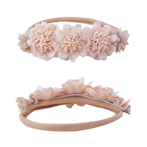 Detail of peach flower headband for babies with chiffon petals and pearl accents