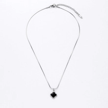 Vue détaillée du collier en argent avec pendentif trèfle noir et fermoir mousqueton robuste