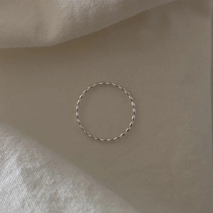 Detailed view of 925 sterling silver olive bead ring with twisted rope texture design