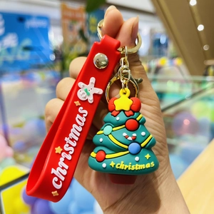 Close-up of a festive Christmas tree keychain with a red strap and vibrant colorful details