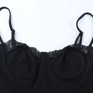 Close-up of the delicate black lace trim and intricate fabric texture on the neckline