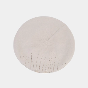 Top view of beige knitted beret showing spiral knit texture and brown sequin trim