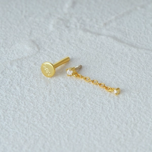 Macro shot of S925 gold-plated cartilage stud featuring heart butterfly chain and crystal