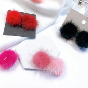Plush faux mink fur pom-pom hair accessories in red, black, and pink colors