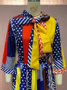 Detailed close-up of colorful patchwork print dress featuring a large bow neckline