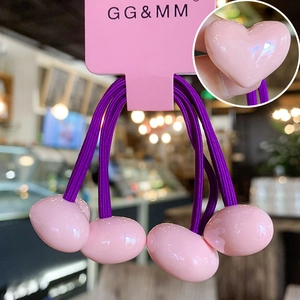 Detail of purple elastic hair ties with pink heart charms on product card