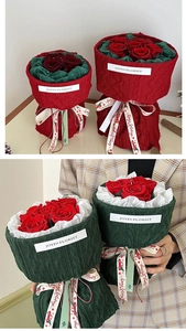 Detail of Christmas knit flower bouquet with red rose, festive ribbons and textile texture
