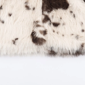 Western style cow pattern faux fur coat featuring dense black and white plush fibers