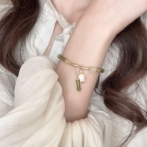 Detail view of New Chinese style bamboo resin bracelet with floral charms and gold links