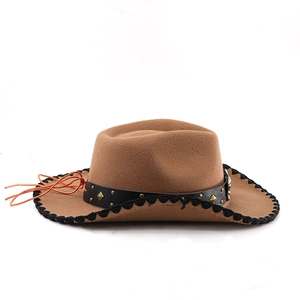 Detail of brown western cowboy hat featuring black leather band with golden studs