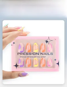 Close-up of almond press-on nails with colorful wave patterns in a pink display box