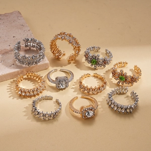 Luxury 5-piece gold and silver stackable rings with green crystals and flower motifs
