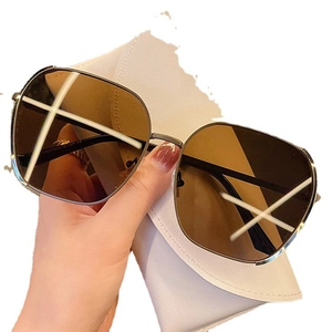 Chic oversized gold metal sunglasses with brown lenses and white leather pouch case