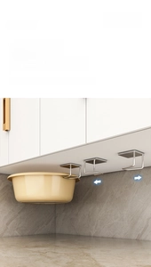 Detail of adjustable stainless steel hooks showing basin storage on cabinet bottom