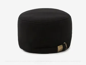 Detail of winter flat top cap featuring bronze metal buckle and wool blend texture