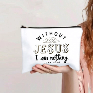 Close-up of white canvas makeup bag with black zipper and printed religious quote