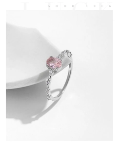 Detail of s925 silver ring featuring pink oval gemstone and bead-set diamond accents