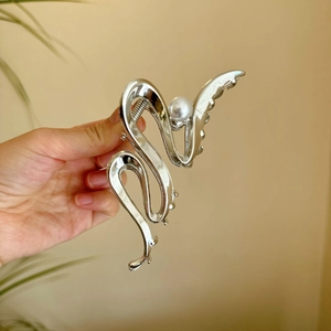 Minimalist silver shark hair claw with abstract snake design and pearl detail