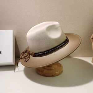 Detail of wool fedora hat with gradient beige to camel tone and beaded tassel band