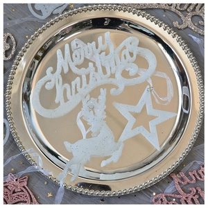 White glittery Christmas ornaments featuring reindeer and stars on a gold beaded tray