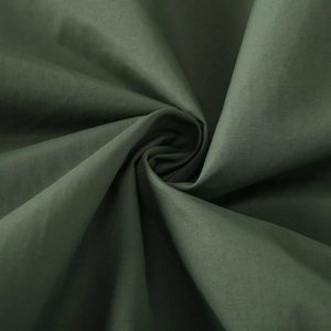Macro shot of dark green windbreaker fabric showing durable texture and weave structure