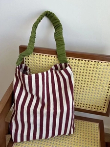 Striped knit tote bag with green ruffled handle and red white contrast design