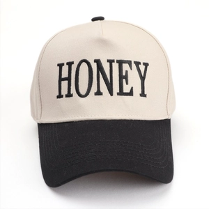Two-tone baseball cap featuring beige crown and black brim with HONEY letter embroidery