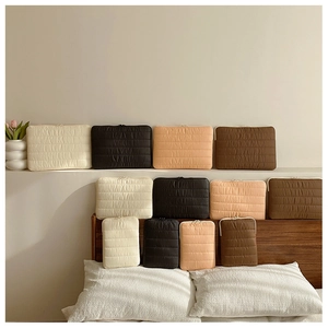 Puffy quilted laptop and tablet sleeves in white, black, apricot, and brown finishes