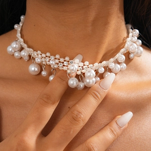 Detail view of Baroque pearl choker with rhinestone mesh and large pearl drop pendant