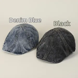 Detail shot of vintage washed denim flat caps in blue and black with premium stitching