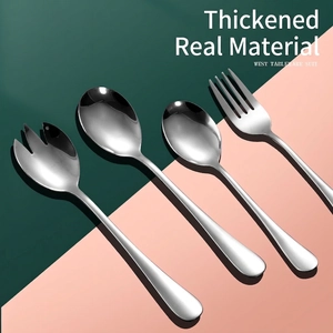 Polished stainless steel cutlery set with spoons and forks on split colored background