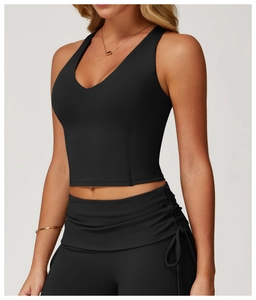 Side view of black V-neck sports vest and matching shorts on professional model
