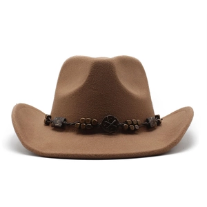 Detailed view of a brown wool felt cowboy hat with beaded band and metallic badge detail
