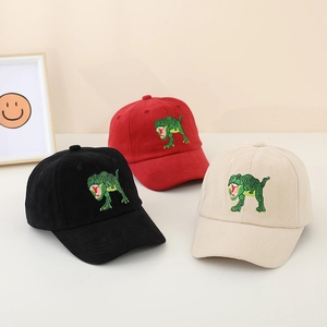 Close-up of three kids' baseball caps in black, red, and beige with dinosaur embroidery