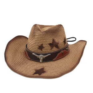 Brown straw cowboy hat with metallic bull head decor and star patterns on white background